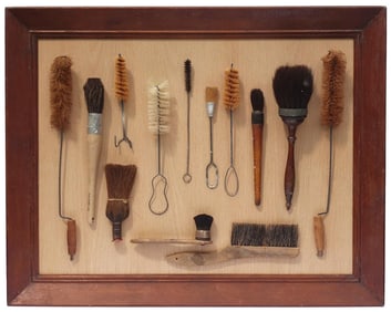 An unusual and decorative framed collection of brushes