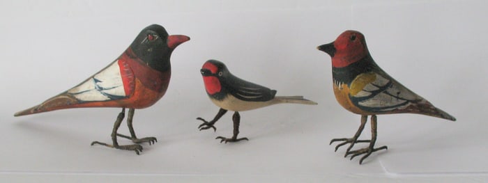 Group of three antique folk art bird carvings.