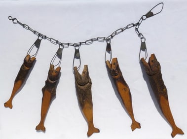 A rustic stringer of five hand carved fish