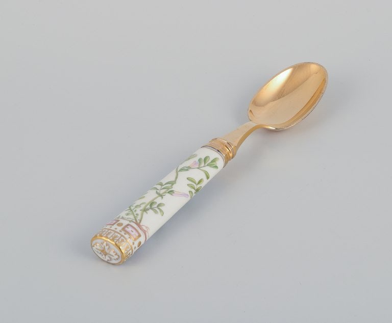 Royal Copenhagen Flora Danica/Georg Jensen. Dining spoon, hand-painted with Flora Danica motif.: Royal Copenhagen Flora Danica/Georg Jensen. Dining spoon, hand-painted with Flora Danica motif. Handle by Georg Jensen in gilt sterling silver. 1970s/80s. In good condition with two hairline cracks. S