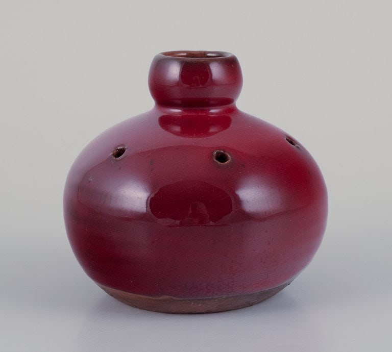 Gerard Hofmann (1917-1965), French ceramicist, own workshop. Perforated vase with ox blood glaze.: Gerard Hofmann (1917-1965), French ceramicist, own workshop. Perforated vase with ox blood glaze. Handmade. Circa 1960. In excellent condition. Signed. Dimensions: D 9.0 cm x H 9.0 cm. Reserve: $168.0