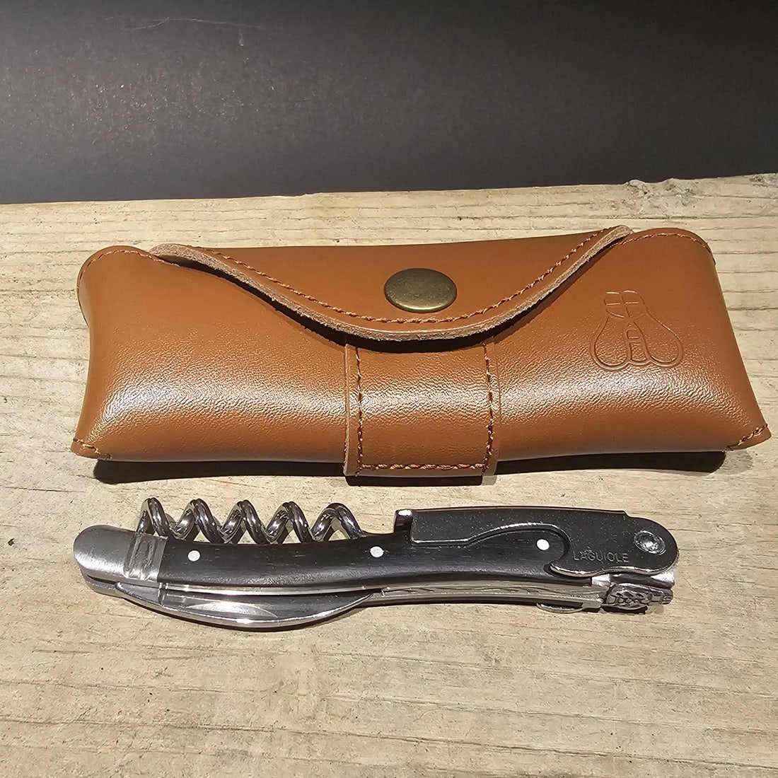 Laguiole Corkscrew with Ebony Wood Handles Leather Case: 4 1/2" long x 5/8" Wide Leather Case is 5" Long Nice quality, brand new, never used heavy waiters style Laguiole corkscrew with ebony wood handles. This piece is made from stainless steel with a ribbe