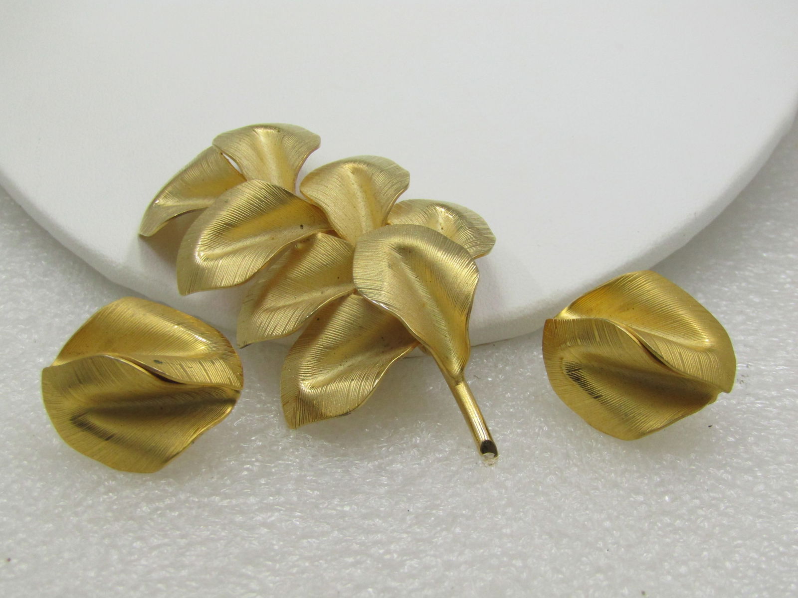 Vintage Gold Leaf Stem Brooch & Earrings Set, 1960's: Vintage Gold Leaf Stem Brooch & Earrings Set, 1960's. 2" tall and appx. 1.5" wide with earrings made of two curved shapes similar to the design in the brooch that are appx. 7/8" long. The finish is go