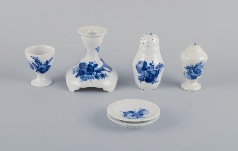Royal Copenhagen Blue Flower Braided. Six pieces including a candlestick, egg cup, pepper shaker,: Royal Copenhagen Blue Flower Braided. Six pieces including a candlestick, egg cup, pepper shaker, salt shaker, and two butter dishes. Various dating. First factory quality. Egg cup is second factory q