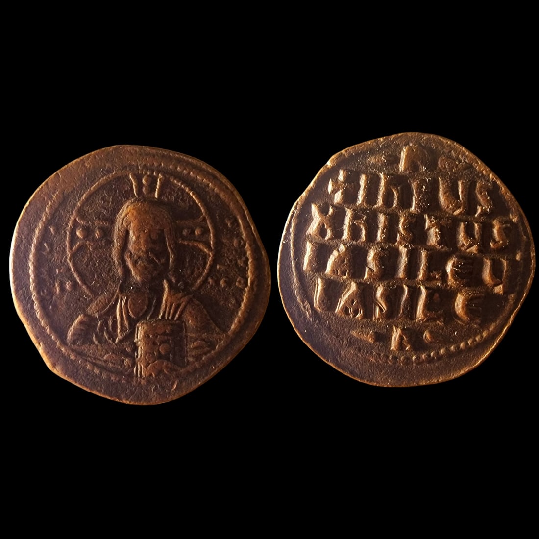 The Byzantine Empire: Title: The Byzantine Empire Description: Byzantine Bronze Follis featuring Christ (10th-11th Century). The obverse shows a detailed portrait of Christ with a halo and cross, holding the Gospels, while