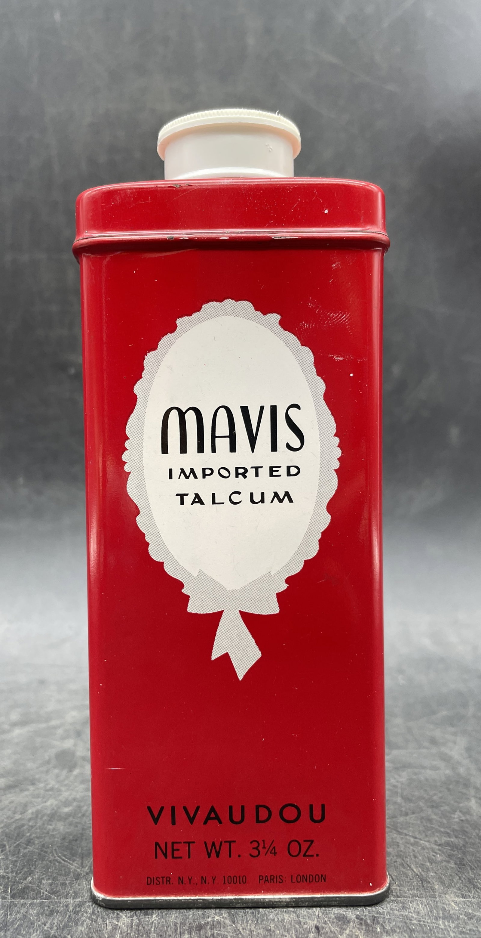 VINTAGE TIN MAVIS NEW YORK IMPORTED TALCUM POWDER VIVAUDOU RED: Title: VINTAGE TIN MAVIS NEW YORK IMPORTED TALCUM POWDER VIVAUDOU RED Date/Period: unknown Dimension: Approx 5.75" tall x 2.25" x 1.25" Material: metal with some contents Additional Information: VINTA