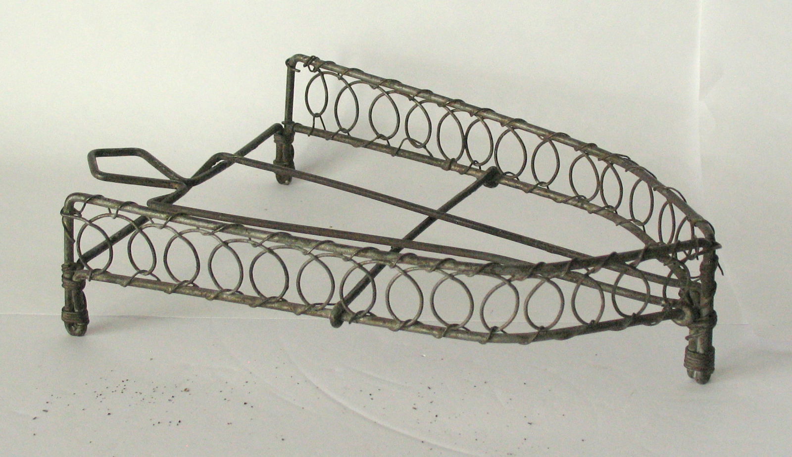 Antique wire trivet in the shape of a flat iron. (1 of 3)
