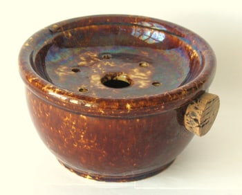 Antique yellow ware soap dish with brown sponge decoration.