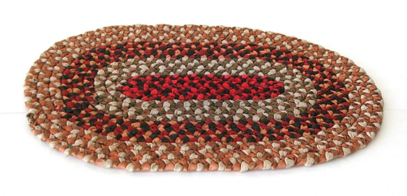 Antique New England oval braided table mat.