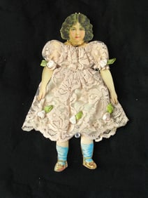 Vintage elaborately dressed paper doll.