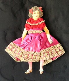 Vintage elaborately dressed paper doll.