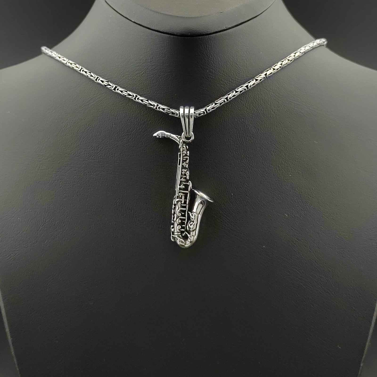 925 Silver Chain with Saxophone Pendant: Title:925 Silver Chain with Saxophone Pendant Description:925 Silver Chain with Saxophone Pendant -Total Weight:22.5g Chain Size: 23.62 in(60cm). Pendant Size:0.55x1.92 in (14x49mm) (Bail included). W