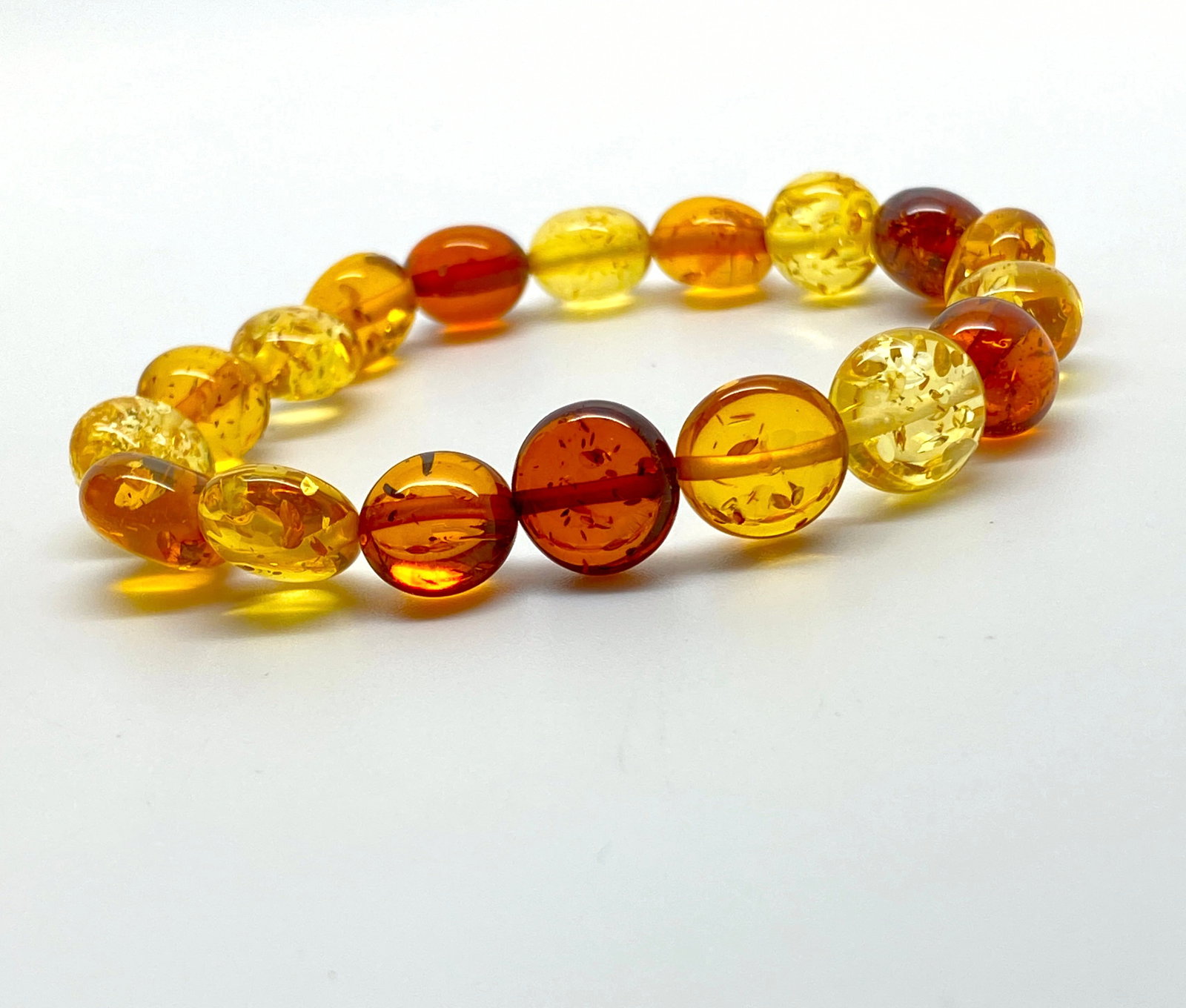 Staggering Amber Bracelet made from Hand Carved Amber beads: Title:Staggering Amber Bracelet made from Hand Carved Amber beads Metal:None Gemstone:Amber Weights:10.3 g Size:Bead size: 12.0 mm Bead size: 0.472 inches Made of: (Reconstituted Amber or Whole Stone)
