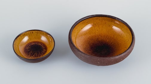 Osa, Denmark. Two small retro unique ceramic bowls with glaze in yellow-brown tones.