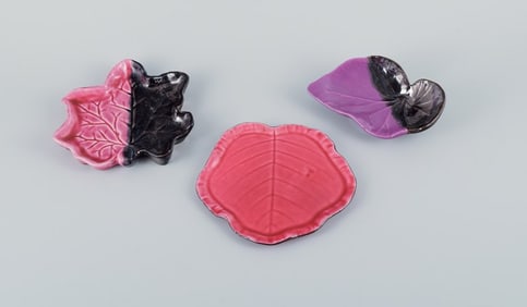 Vallauris, France, three leaf-shaped dishes in brightly colored glazes in shades of pink, violet and