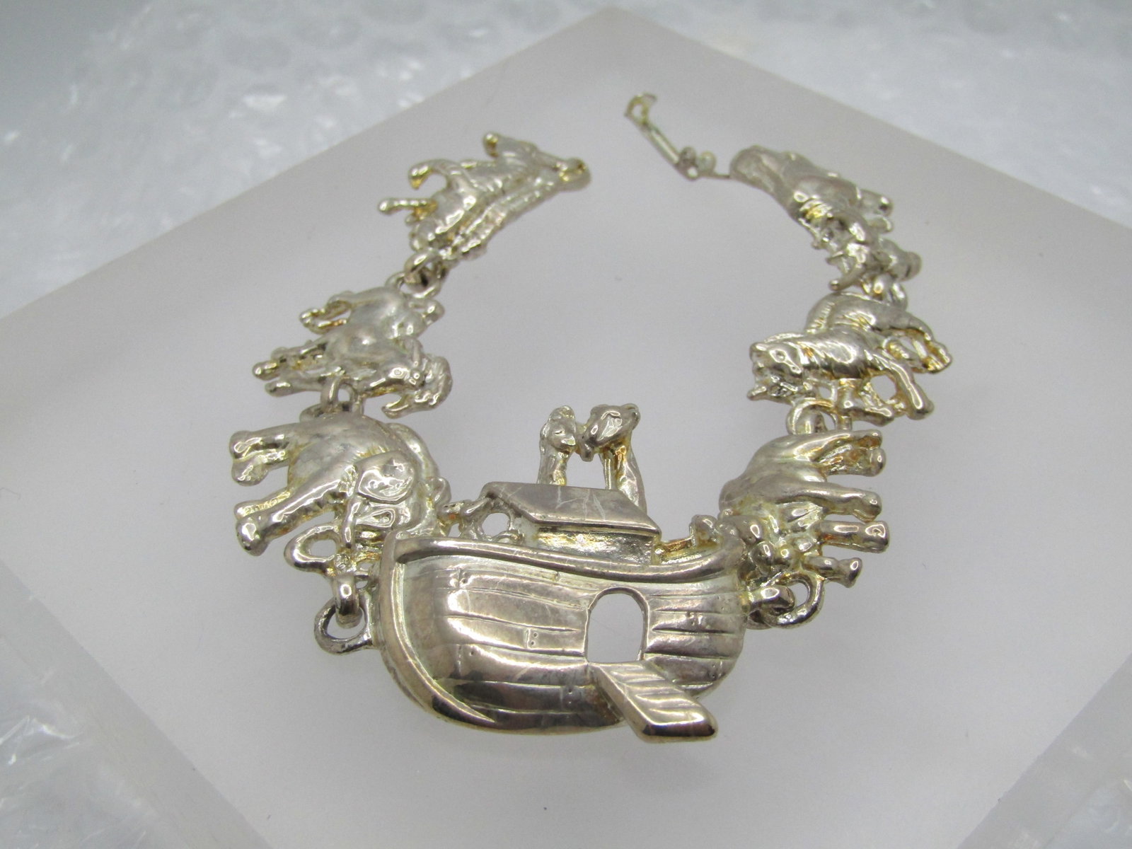 Vintage Noah's Ark Bracelet 7", Silver Tone: Vintage Noah's Ark Bracelet 7", Silver Tone. The ark is in the center with giraffes sticking up from the top. There are two horses, two zebras, two elephants, two tigers, two rhinos, and a cow/bull. F