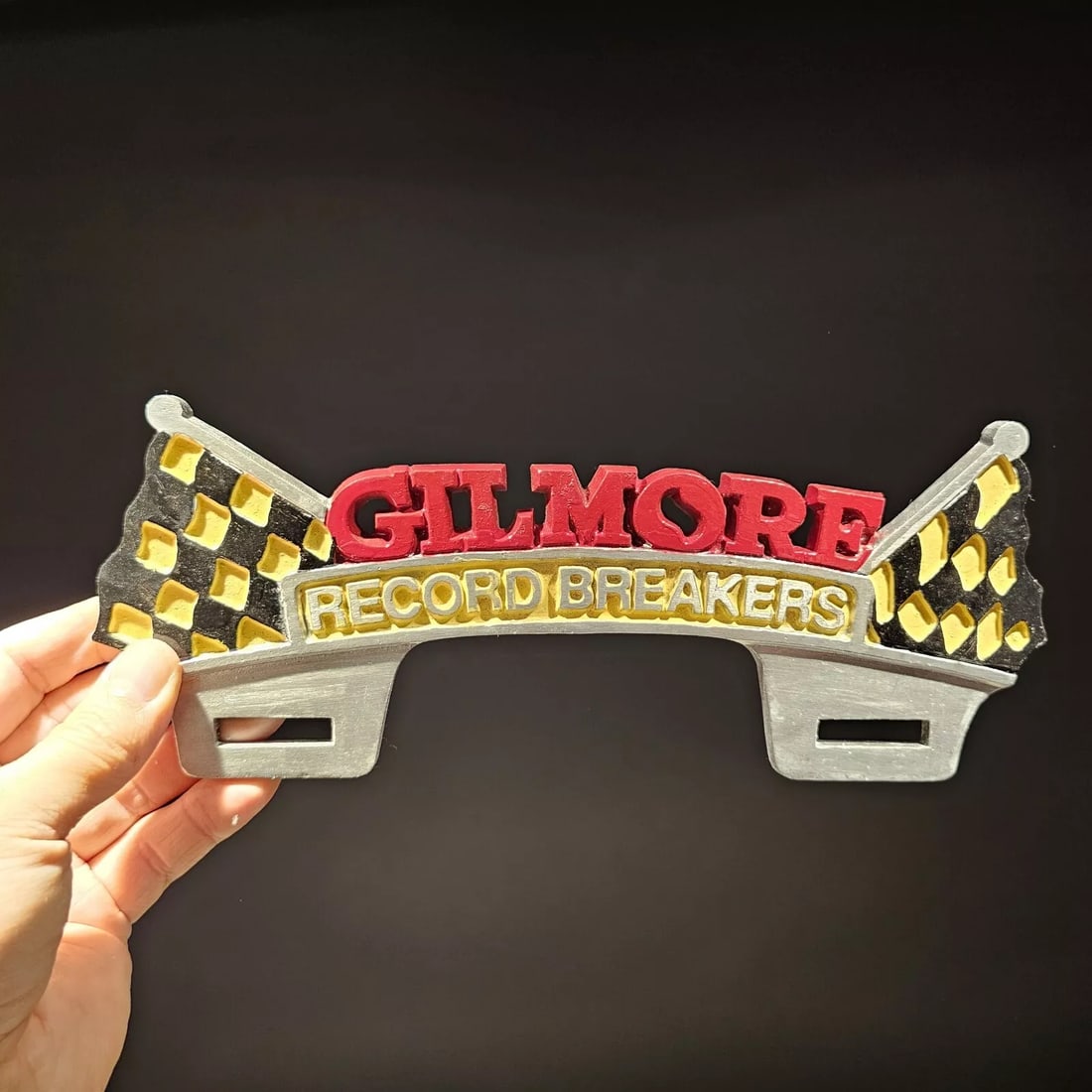 Aluminum Gilmore License Plate Fob Topper: 10 1/2" Wide Wonderful reproduction license plate topper. Good detail aluminum, slightly aged to look like an antique. Certainly hard to tell its age. Reserve: $25.00 Shipping: Domestic: Flat-rate of 