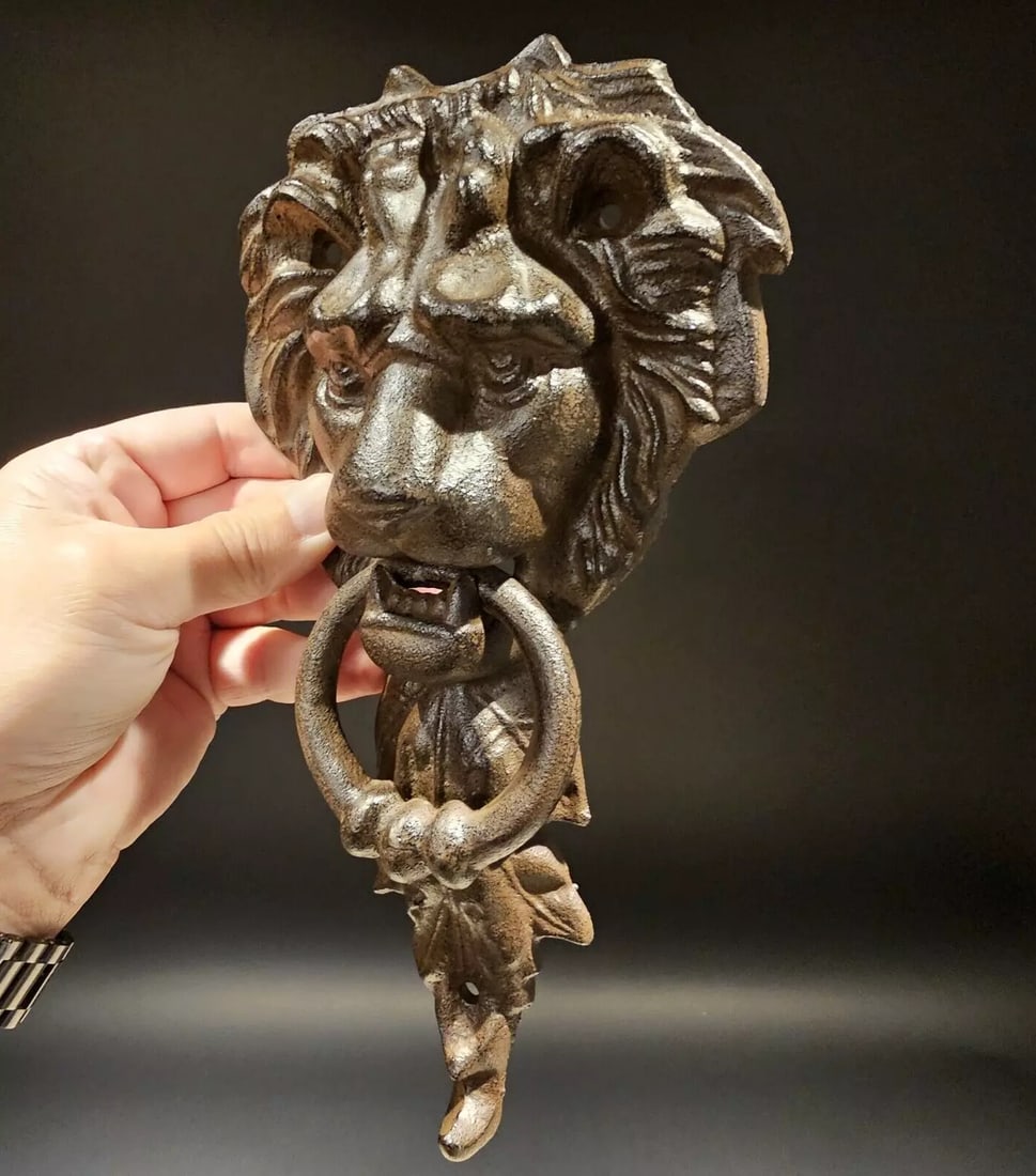 Cast Iron Lion Door Knocker w Hook: 10 3/4" Tall x 5 1/4" wide 2 lbs 7oz Nice heavy quality reproduction cast iron door knocker! As you can see this is a solid lion face door knocker. The ring in the lions mouth serves as the knocker. N