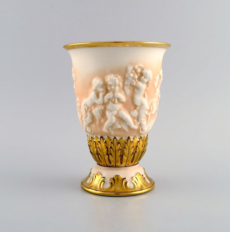 Capodimonte, Italy. Antique porcelain vase with putti in relief and hand-painted gold decoration.: Capodimonte, Italy. Antique porcelain vase with putti in relief and hand-painted gold decoration. Early 20th century. Measures: 18 x 13.5 cm. In excellent condition. Signed. Reserve: $280.00 Shipping: