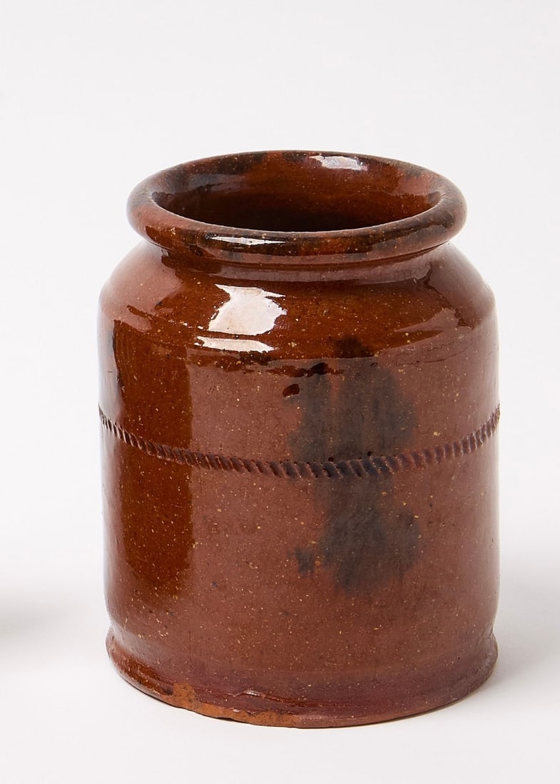 Glazed Redware Jar: Pennsylvania Glazed Redware Jar Mid 19th Century Pennsylvania Glazed Redware Jar, with Coggled Banded Decoration, Tooled Lip and Footed Base. Size: Height 5" X Diameter 4" Condition: Some Roughness to