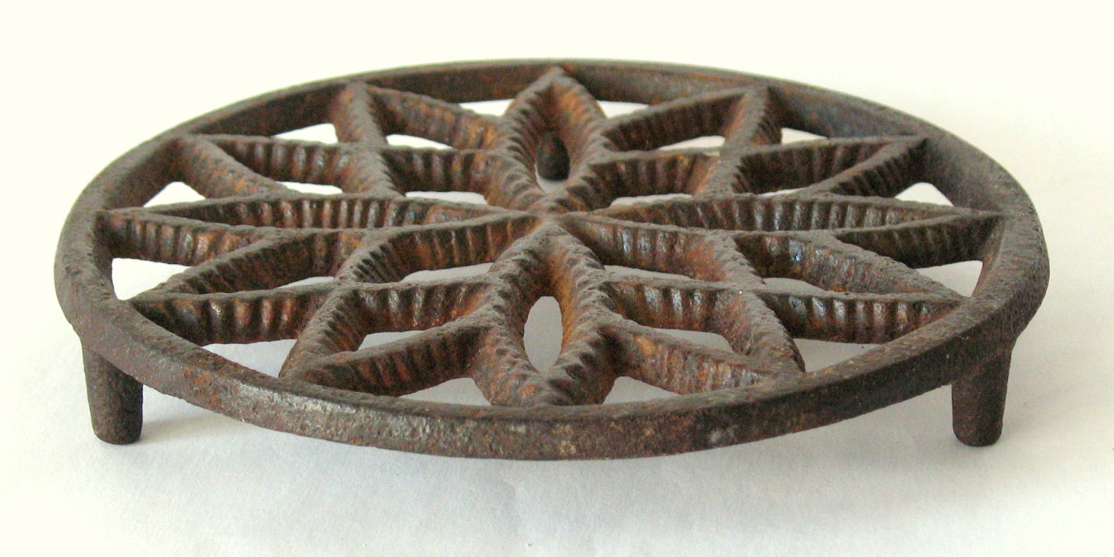 Antique cast iron Pennsylvania hearth trivet.: Title: Antique cast iron Pennsylvania hearth trivet. Date/Period: 1930's Dimension: 5 1/4” diameter Additional Information: Nice antique cast iron Pennsylvania heath trivet in all original patin