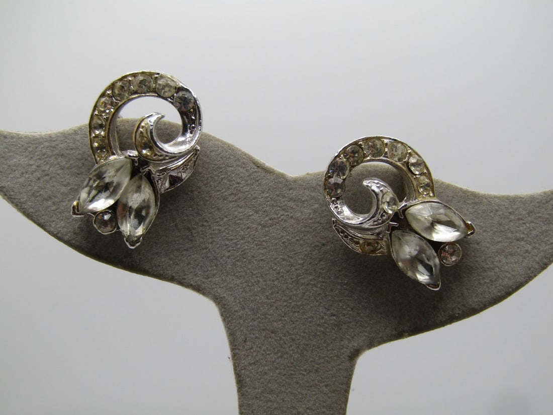Vintage Coro Rhinestone Earrnigs, Screwback 1940's-1950's: Vintage Coro Rhinestone Earrnigs, Screwback 1940's-1950's. Silver tone screw back earrings with rhinestones in an art deco themed coiled design with marquise blossom like design. Textured and smooth f