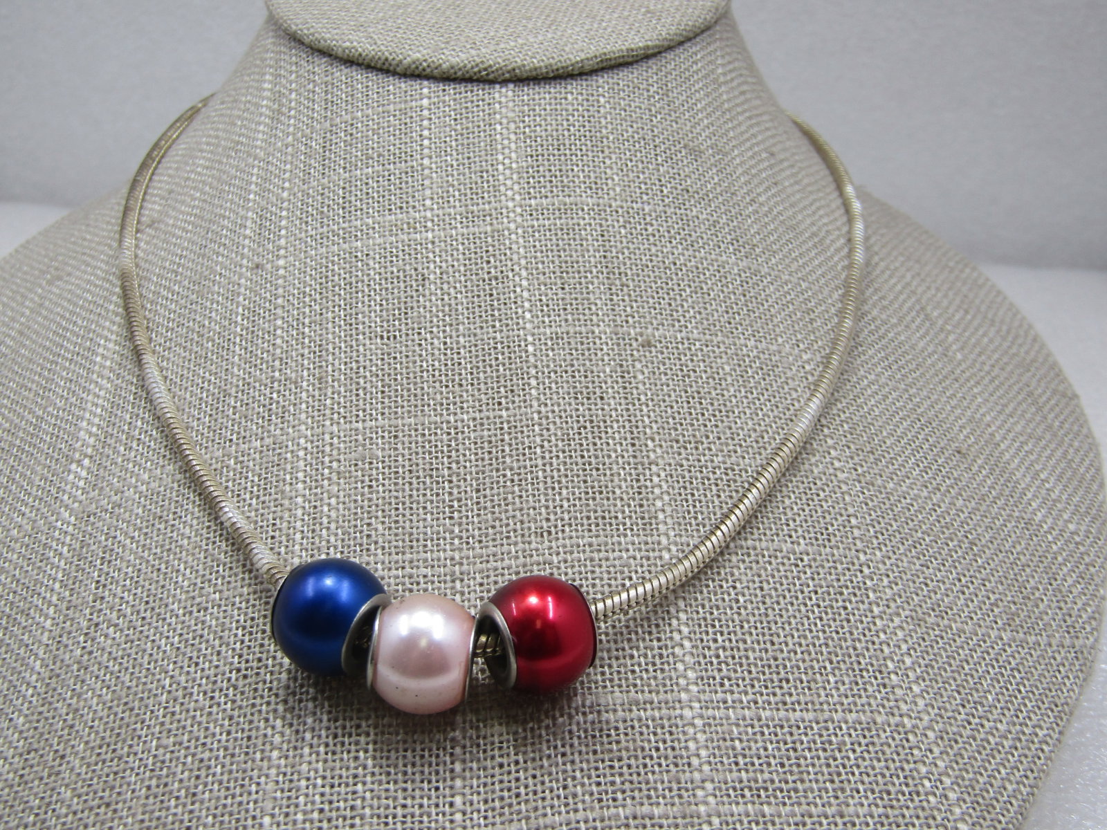 Red, White, & Blue Pearly Slide Bead Serpentine Necklace, 18": Red, White, & Blue Pearly Slide Bead Serpentine Necklace, 18". Paraiotic Vintage - has a .925 tag howerver this does not test as sterling. 2.5mm round serpentine chain with lobster clasp. The beds are