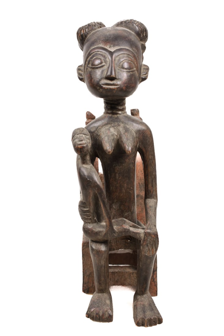 Maternity Figure – Wood – Asante – Ghana: Seated female figures were found in shrines or as part of popular drum ensembles among the Fante / Asante known as Ntan or Ompe. These sculpted maternity figures are prominent parts of the drum stand