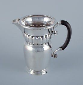 Georg Jensen, large Art Nouveau pitcher in sterling silver. Early and rare model. Hammered finish.