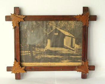 Antique tramp art style frame with corner leaf decoration.