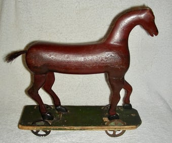 An early and very sculptural primitive horse pull toy dates to the mid-19th century
