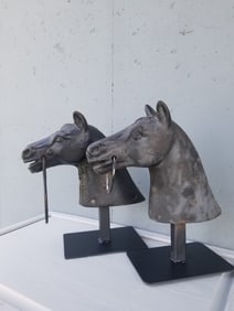 CAST IRON PAIR OF HORSE HEAD HITCHING POSTS.