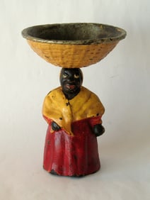 Antique cast iron black lady with a basket soap dish.