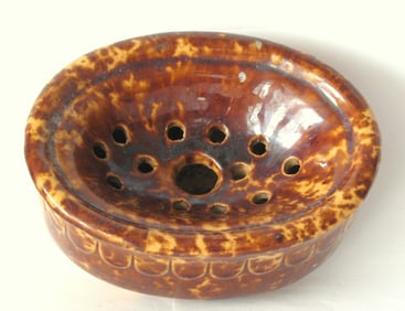 Antique yellow ware soap dish with brown sponge decoration.