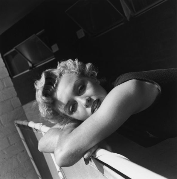 Far Away Look' Marilyn Monroe Circa 1955 Silver Gelatin Print Framed In White: Description 'Far Away Look' Marilyn Monroe circa 1955 Silver Gelatin Print Framed In White Portrait of American actress Marilyn Monroe (1926-1962) leaning her head over a railing and wearing a sleevel