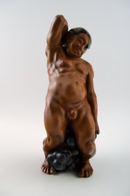 Bing & Grondahl Figurine of a man standing with grapes by Kai Nielsen. Model number 4025. From the