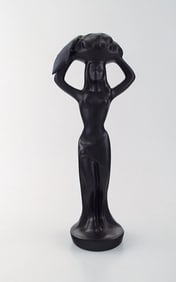 Scandinavian ceramist. Sculpture in black glazed ceramics. Woman carrying basket. 1960's.