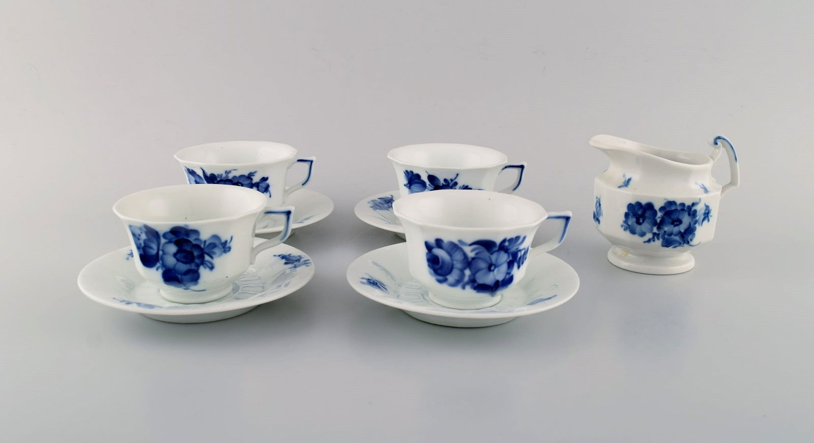 Four Royal Copenhagen Blue Flower Angular coffee cups with saucers and creamer. 1960s.: Four Royal Copenhagen Blue Flower Angular coffee cups with saucers and creamer. 1960s. The cup measures: 9 x 5.5 cm. Saucer diameter: 14 cm. Cream jug measures: 11.5 x 9 cm. In excellent condition. St