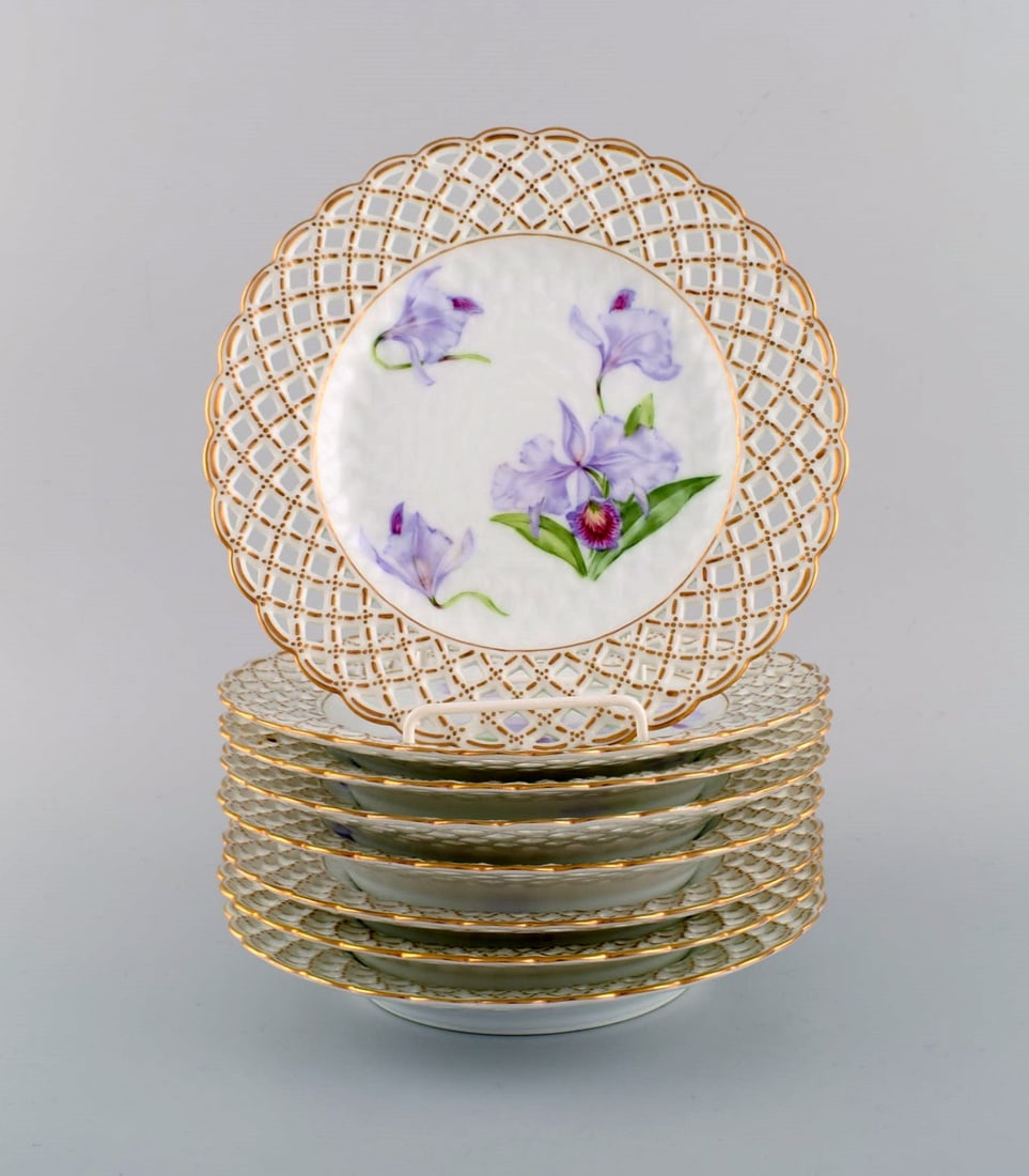 Eight antique Royal Copenhagen plates in openwork porcelain with hand-painted purple lotus flowers. (1 of 5)
