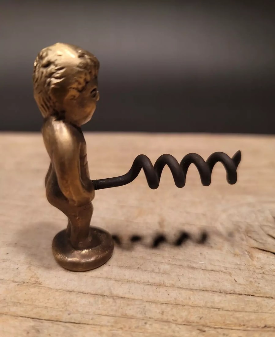 Boy Brass & Iron Corkscrew: 2 1/2" Tall x 2 1/4" Wide Nice quality reproduction corkscrew. Made to look just like an original antique but is new. Wonderful tool marks patina and signs of being handmade. Great for use or display!