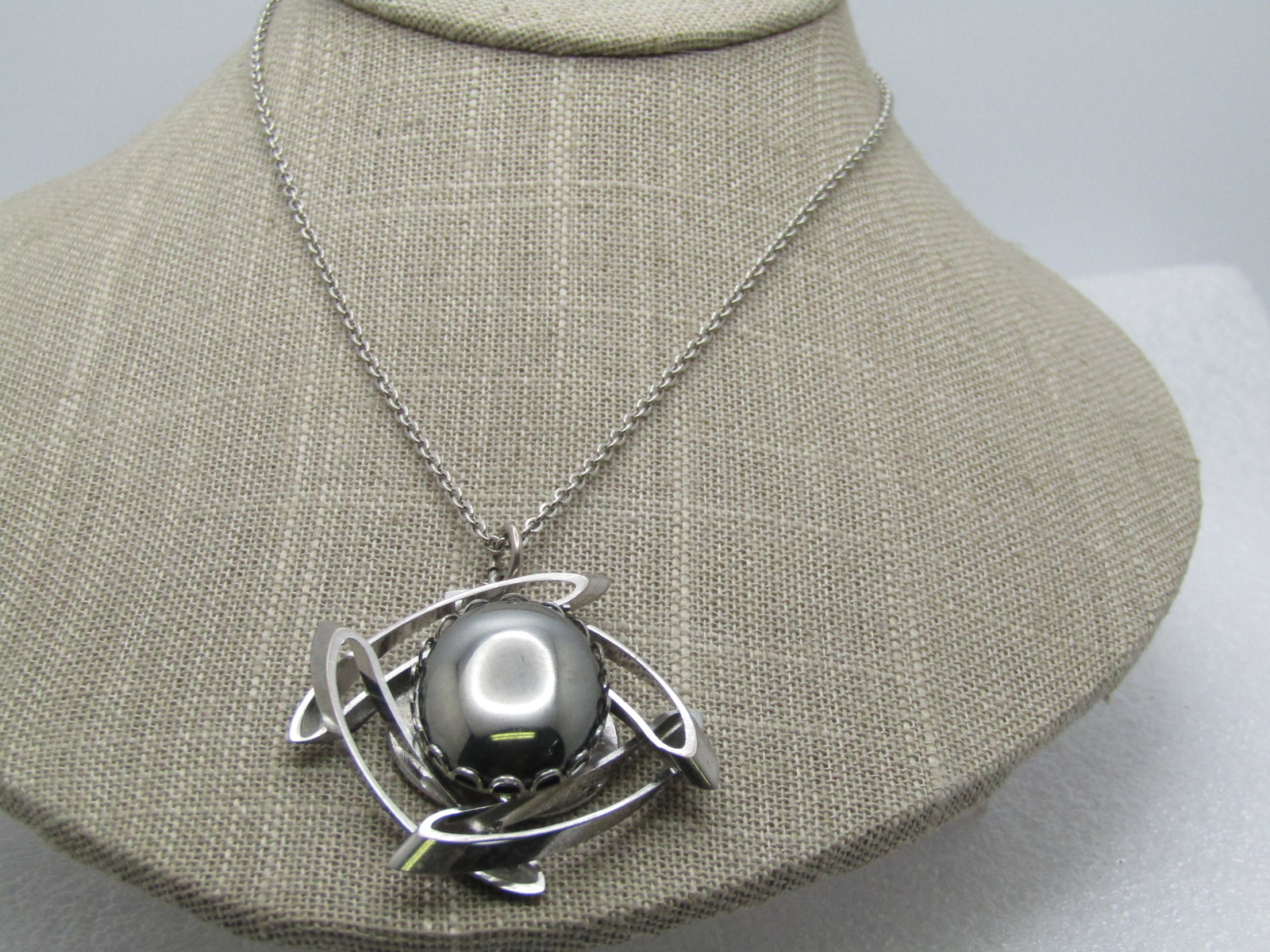 Vintage Hematite Framed Neckalce, 15.5", 1960's-1970's: Vintage Hematite Framed Neckalce, 15.5", 1960's-1970's. Silver tone with a hematite that is appx. 1" by 3/4" set in an open scalloped bezel and framed with four open curved overlapping 1.5" accents th