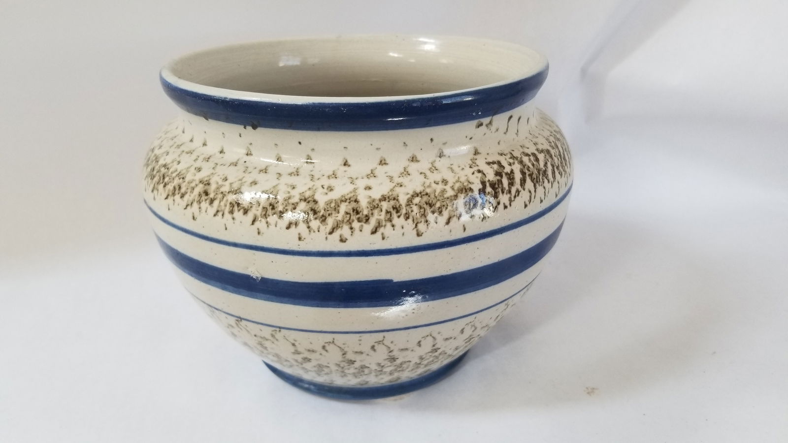 White-glazed stoneware jardiniere: Olive green sponging with navy blue bands. 9 1/2" diameter, . Theae are Ohio c. 1920s. Possibly Roseville. Shipping: Domestic: Flat-rate of $25.00 to anywhere within the contiguous U.S. International: