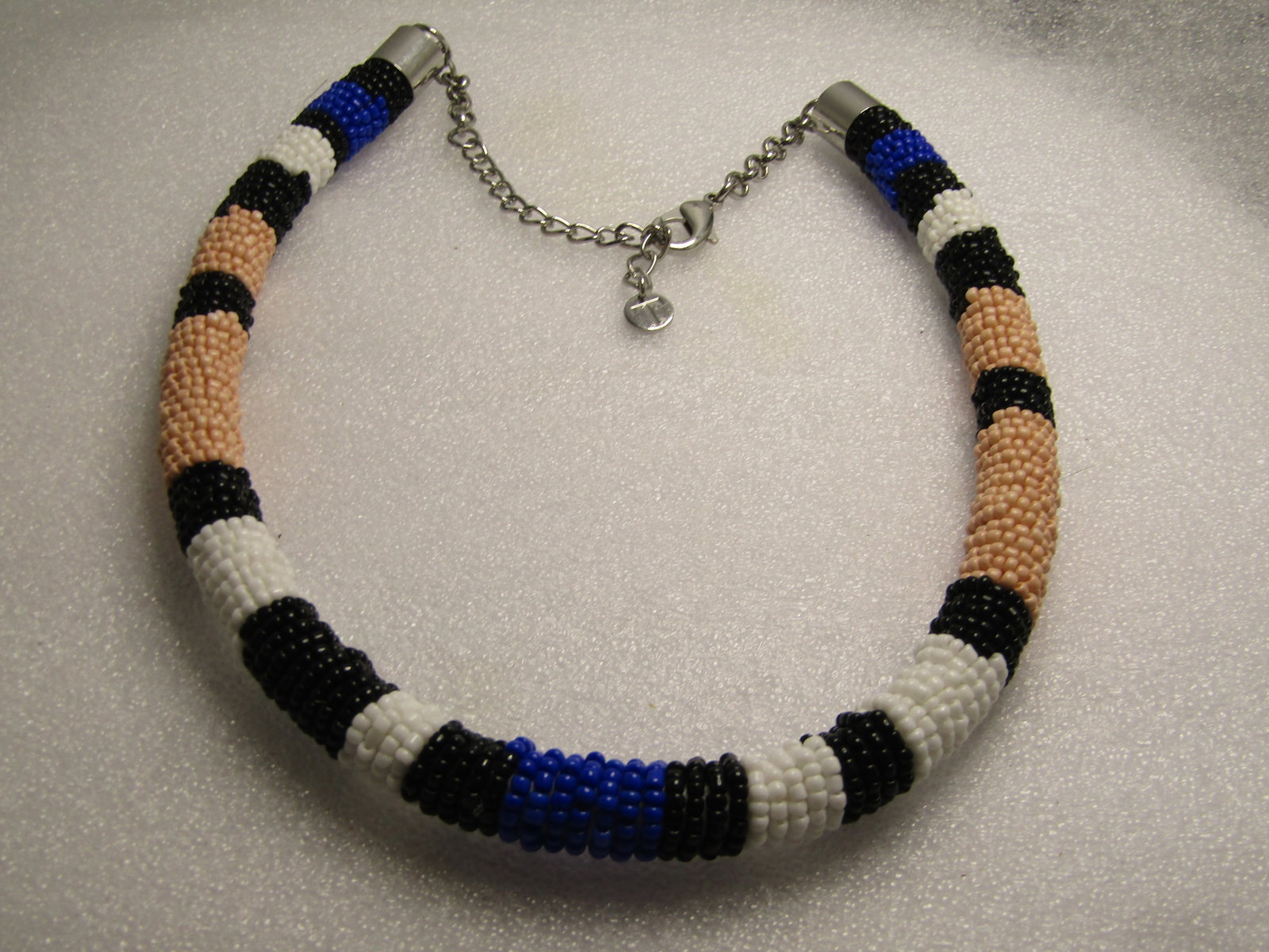 Pink/Blue/Black/white Seed Beaded Tubular Neacklace, Hand Beaded 18"-23", 1980's-1990's, Signed T.: Pink/Blue/Black/white Seed Beaded Tubular Neacklace, Hand Beaded 18"-23", 1980's-1990's. This is approximately 12.5mm wide and a round tubular design with a stuffed center to hold the shape. All beads