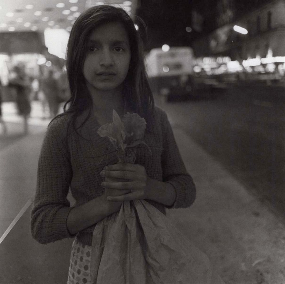 DIANE ARBUS - Girl selling plastic orchids, NYC, 1963: Artist: DIANE ARBUS Print Title: Girl selling plastic orchids, NYC, 1963 Medium: Duotone Print Printed 2000’s in Germany Image size (inches) approx. 8 x 8” Diane Arbus (1923 –1971),w