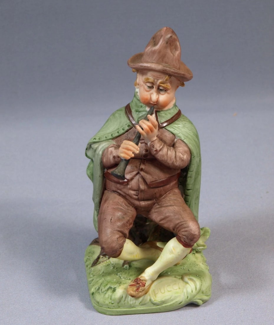 CAPODIMONTE Italy Pucci Man playing trumpet Vintage: This is a beautiful figurine made by Pucci in Italy. The figurine shows precision craftsmanship featuring with lots of details. It is marked with Capodimonte mark. This figurine measures 6 3/4" tall a