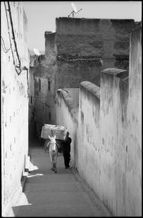 Edition of 10 - Man and Donkey; 2017: Edition of 10 - Man and Donkey, Fes, Morocco, Silver Gelatin Photograph Edition of 10 + 5 APs. Front: Signature and edition number with artists blind stamp. Back: Ink stamp and print details. Mounted: