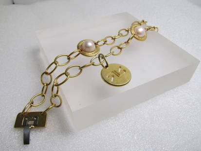 Double Strand Faux Pearl Bracelet, Signed Rebecca Bronze, 1990's-2000's, 7.5", Italian: Double Strand Faux Pearl Bracelet, Signed Rebecca Bronze, 1990's-2000's, 7.5". Made in Italy. This has a dangling charm toward the one clasp of the cut-out maker's mark for Rebecca Bronze. The history