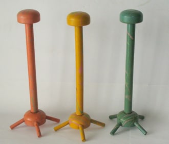 Group of three vintage millinery shop hat display stands.