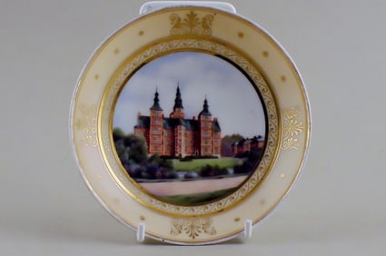 Antique Royal Copenhagen plate with motif of Rosenborg in overglaze technique.
