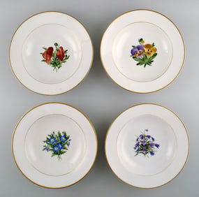 4 antique Royal Copenhagen deep plates in flora danica style.